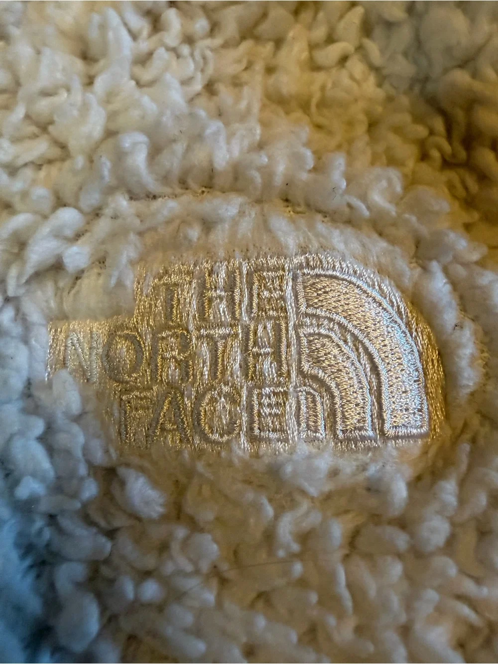 The North Face plush cream